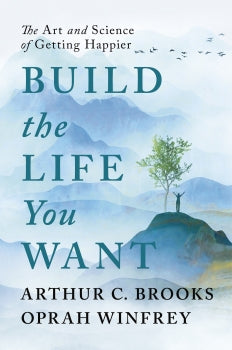 Book cover of 'Build the Life You Want' with a mountain and tree background